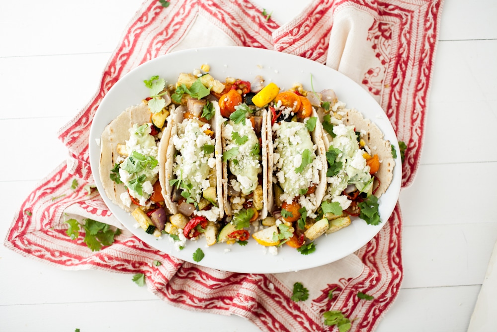 roasted veggie tacos with avocado cream and feta