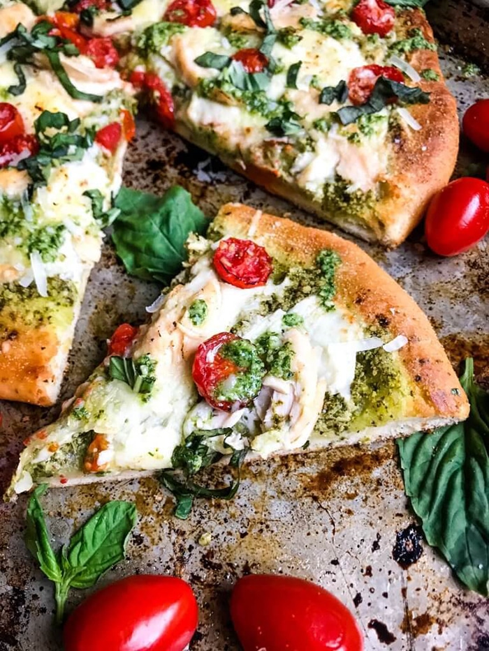 pizza with mozzarella tomato and pesto