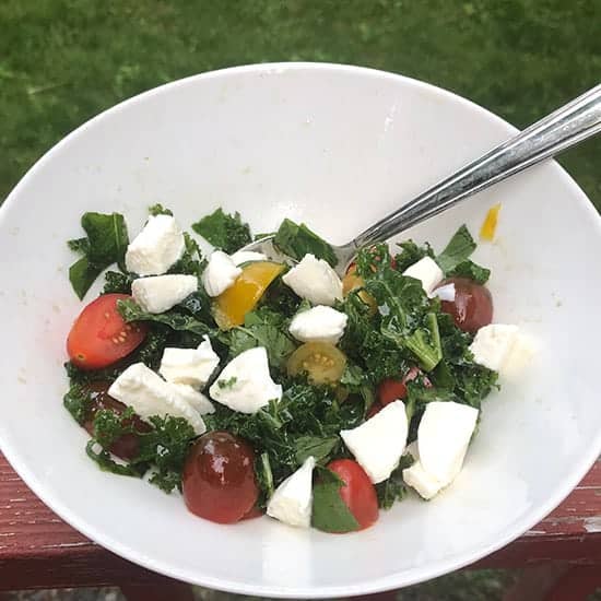 kale mozzarella and tomatoes in a salad bowl