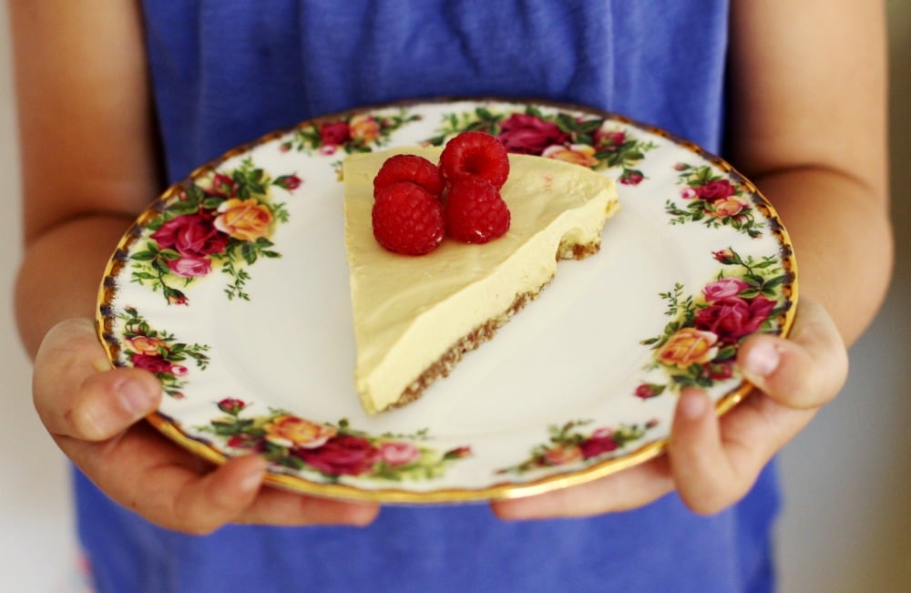 No-Bake Raw Vegan Mango Raspberry Cheesecake Recipe on flower plate