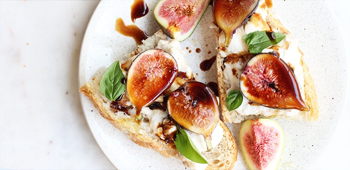 figs burrata and basil with balsamic vinegar reduction on a crostini